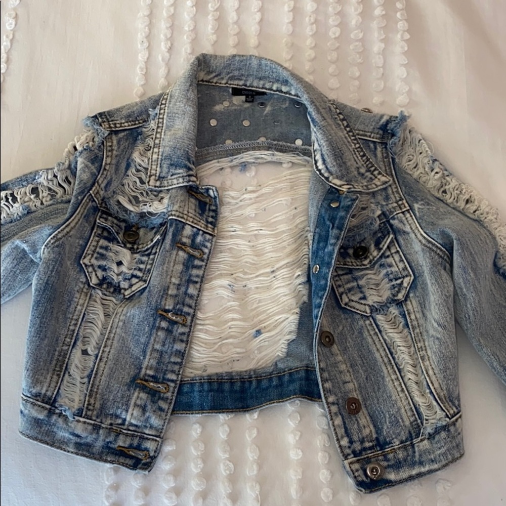 Long sleeve jacket denim with rips in it